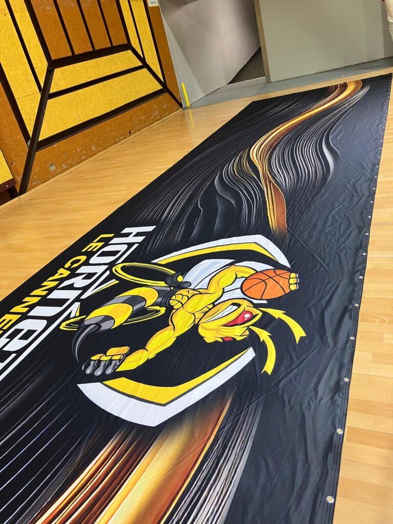 Printed cover with the Le Cannet Hornets logo unrolled on the floor before installation