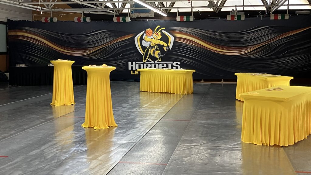 Le Cannet Hornets cover dressing the back wall of a gymnasium set up for a reception