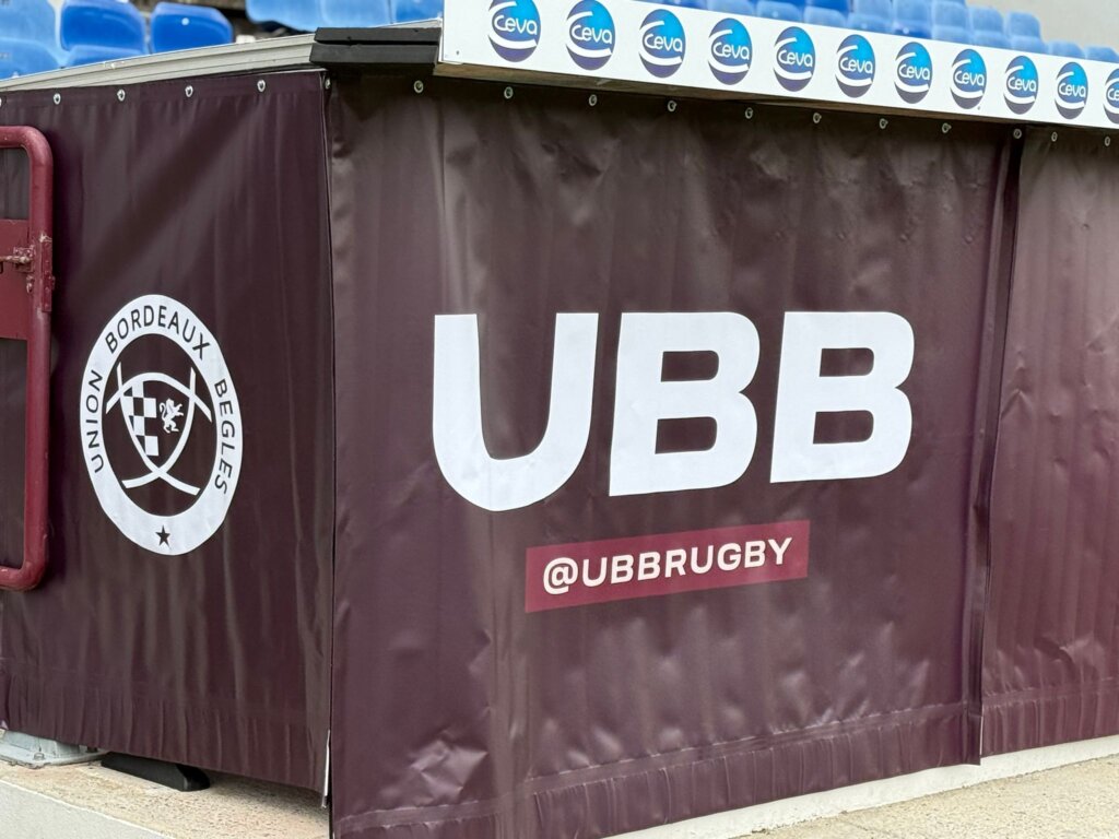 Close-up of eyelet-fitted UBB fabric dressing installed at the pitch side
